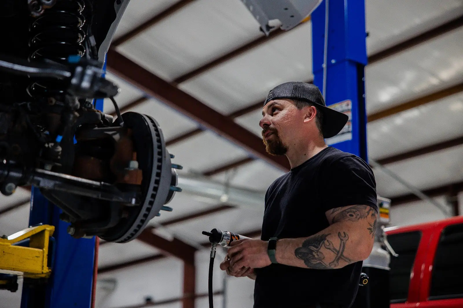 Brake System Installation Mechanic installing brake system on truck at THOR Off-Road shop